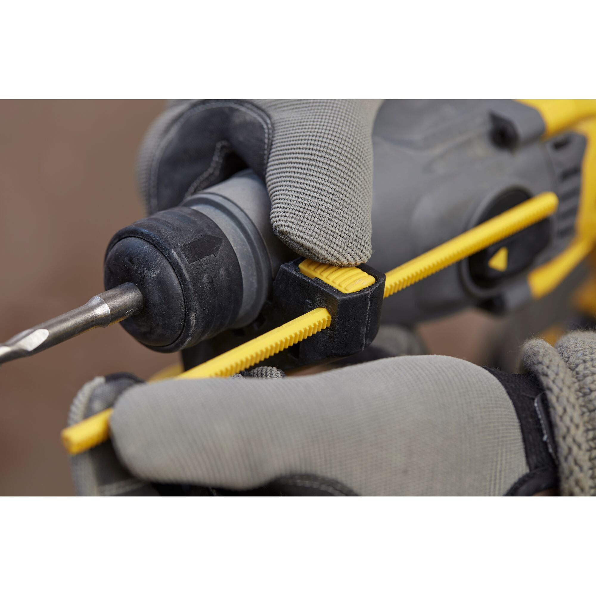 STANLEY SFMCH900M22 photography of depth stop adjustment on cordless drill, close-up view, gray and yellow details.